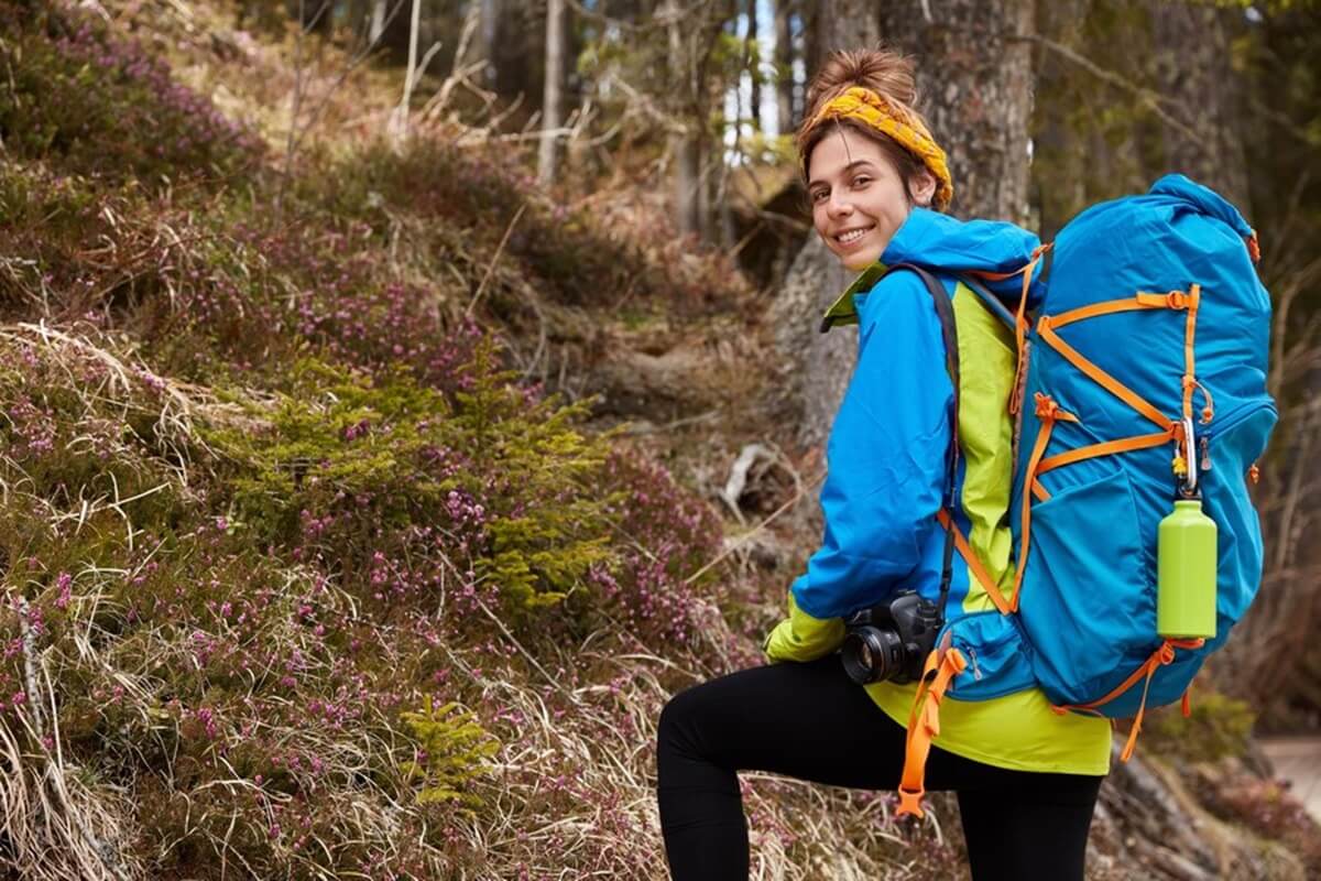 delighted female camper carries backpack professional camera 273609 27179 1